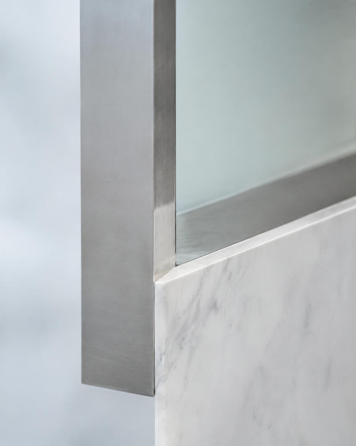 Brushed steel meeting honed marble